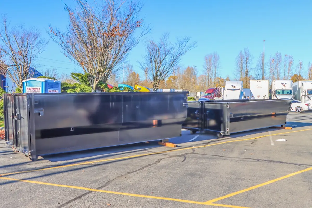 Professional dumpster rental service with roll-off container on residential driveway in Springville